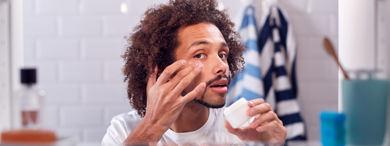 man using face cream