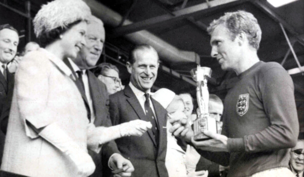 Queen Elizabeth II presents the Jules Rimet trophy to England captain, Bobby Moore